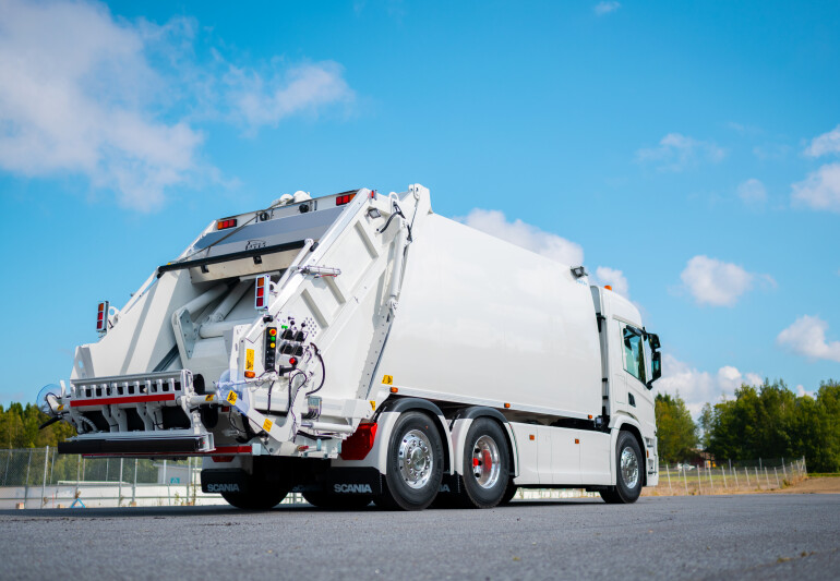 Garbage collection truck used for municipal waste collection on a road